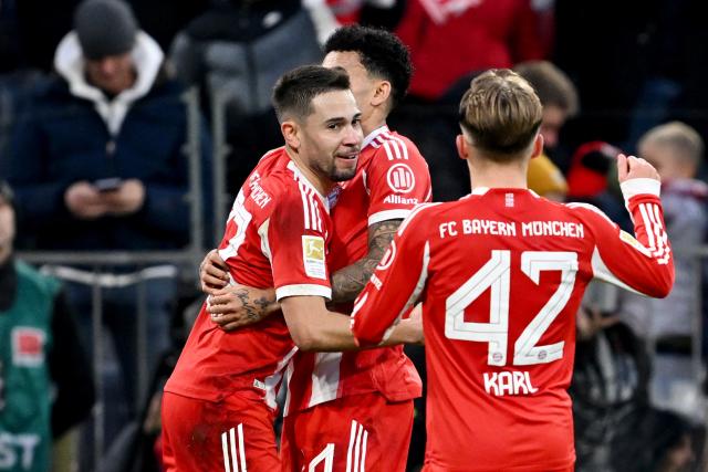 29 November 2025, Bavaria, Munich: Bayern Munich's Raphael Guerreiro (L) celebrates scoring his side's first goal with teammates Luis Diaz (2nd L) and Lennart Karl (R) during the German Bundesliga soccer match between Bayern Munich and FC St. Pauli at Allianz Arena. Photo: Sven Hoppe/dpa - IMPORTANT NOTICE: DFL and DFB regulations prohibit any use of photographs as image sequences and/or quasi-video.