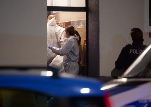 29 November 2025, North Rhine-Westphalia, Duesseldorf: Forensics officers enter a house where a woman and a baby were found dead. It is suspected that the 43-year-old father of the child may have killed them, police and the public prosecutor's office said. Photo: Henning Kaiser/dpa