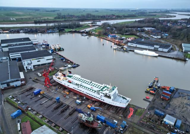 30 November 2025, Lower Saxony, Leer: An aerial photo shows the Borkum ferry "Westfalen" being refurbished and overhauled in Leer during the winter months, with the current mild temperatures providing ideal conditions. Photo: Lars Penning/dpa