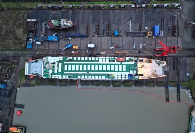 30 November 2025, Lower Saxony, Leer: An aerial photo shows the Borkum ferry "Westfalen" being refurbished and overhauled in Leer during the winter months, with the current mild temperatures providing ideal conditions. Photo: Lars Penning/dpa