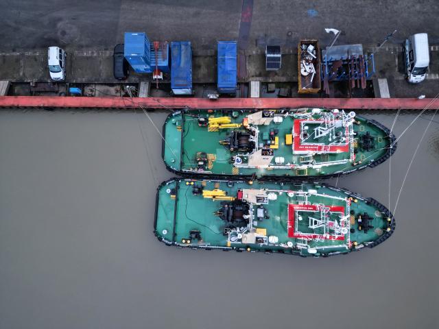 30 November 2025, Lower Saxony, Leer: An aerial view shows two tugs using the port of Leer as a winter berth. Photo: Lars Penning/dpa