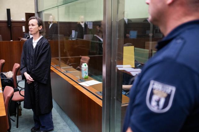 01 December 2025, Berlin: The accused, a suspected IS supporter (C), sits behind a pane of glass in the courtroom at the start of his trial, while his defence lawyer Susanne Lange stands in front. The 19-year-old Russian citizen is accused of planning an attack on the Israeli embassy in Berlin and of supporting a terrorist organization abroad, according to the federal prosecutor's office. Photo: Christophe Gateau/dpa