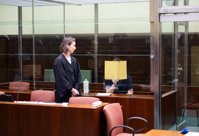 01 December 2025, Berlin: The accused, a suspected IS supporter (R), sits behind a pane of glass in the courtroom at the start of his trial, while his defence lawyer Susanne Lange stands in front. The 19-year-old Russian citizen is accused of planning an attack on the Israeli embassy in Berlin and of supporting a terrorist organization abroad, according to the federal prosecutor's office. Photo: Christophe Gateau/dpa
