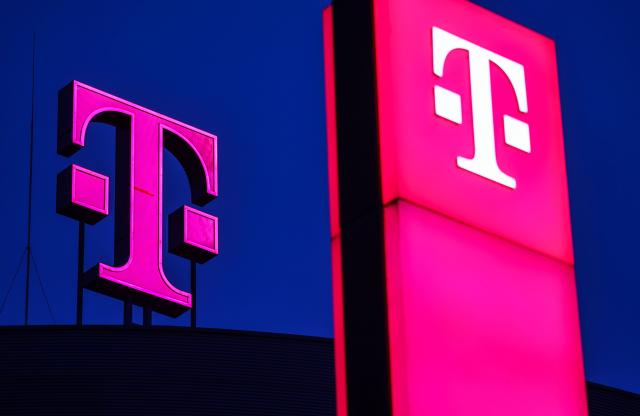 FILED - 26 February 2025, North Rhine-Westphalia, Bonn: Deutsche Telekom logos light up at the company's headquarters in Bonn. Photo: Oliver Berg/dpa