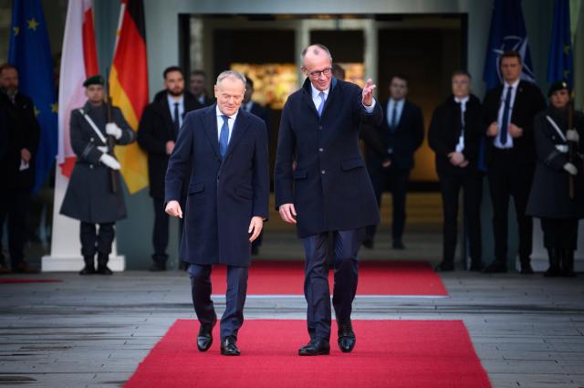 01 December 2025, Berlin: Germany's Chancellor Friedrich Merz (R) welcomes Donald Tusk, Poland's Prime Minister, with military honors in front of the German Chancellery during the German-Polish intergovernmental consultations. Photo: Bernd von Jutrczenka/dpa