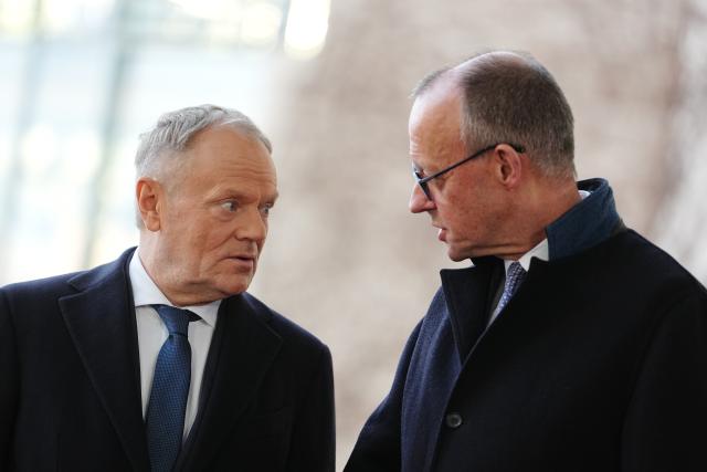 01 December 2025, Berlin: Germany's Chancellor Friedrich Merz (R) welcomes Donald Tusk, Prime Minister of Poland, with military honors in front of the German Chancellery during the German-Polish intergovernmental consultations. Photo: Kay Nietfeld/dpa