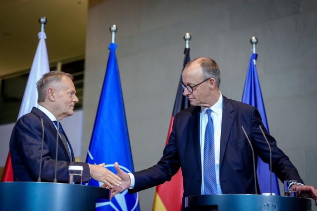 01 December 2025, Berlin: German Chancellor Friedrich Merz and Polish Prime Minister Donald Tusk (L), shake hands at the end of their joint press conference on the occasion of the German-Polish government consultations at the Federal Chancellery in Berlin. Photo: Kay Nietfeld/dpa