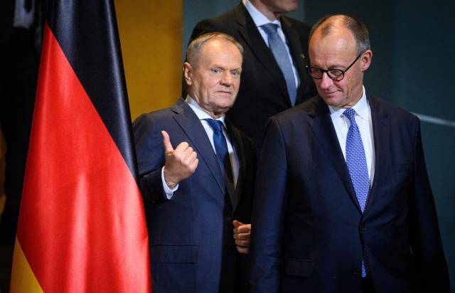 01 December 2025, Berlin: German Chancellor Friedrich Merz (R) and Donald Tusk, Prime Minister of Poland, arrive for a group photo at the German-Polish government consultations in the Federal Chancellery in Berlin. Photo: Bernd von Jutrczenka/dpa