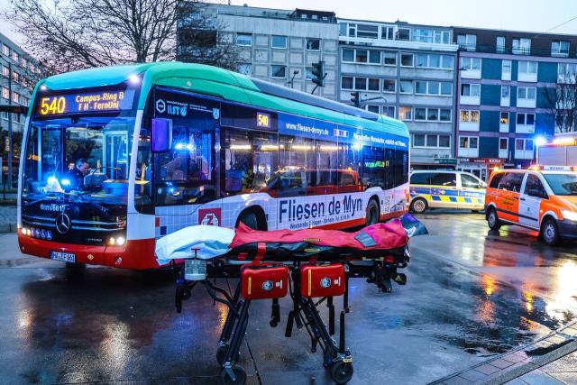 02 December 2025, North Rhine-Westphalia, Hagen: A stretcher stands in front of a bus after an eleven-year-old was knocked down and seriously injured on his way to school in Hagen. According to police, the boy suddenly stepped onto the road at the bus station (ZOB). Photo: Alex Talash/dpa