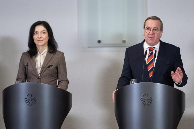 02 December 2025, Berlin: Katherina Reiche, German Minister for Economic Affairs and Energy, and Boris Pistorius, German Minister of Defense, speak at a press conference during a meeting between representatives of the security and defense industry as well as the automotive and supplier industry and the German government. Photo: Christophe Gateau/dpa