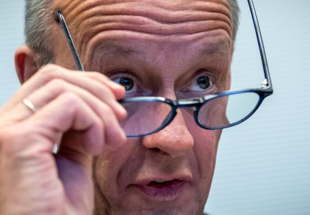 02 December 2025, Berlin: German Chancellor Friedrich Merz cleans his glasses before the start of the Christian Democratic Union of Germany (CDU) and the Christian Social Union in Bavaria (CSU) parliamentary group meeting in the Bundestag. Photo: Michael Kappeler/dpa