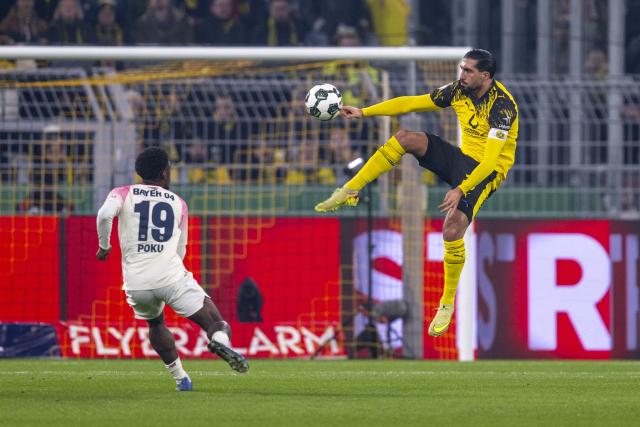02 December 2025, North Rhine-Westphalia, Dortmund: Borussia Dortmund's Emre Can (R) and Leverkusen's Ernest Poku battle for the ball during the German DFB Cup soccer match between Borussia Dortmund and Bayer Leverkusen at the Signal Iduna Park. Photo: David Inderlied/dpa - WICHTIGER HINWEIS: Gemäß den Vorgaben der DFL Deutsche Fußball Liga bzw. des DFB Deutscher Fußball-Bund ist es untersagt, in dem Stadion und/oder vom Spiel angefertigte Fotoaufnahmen in Form von Sequenzbildern und/oder videoähnlichen Fotostrecken zu verwerten bzw. verwerten zu lassen.
