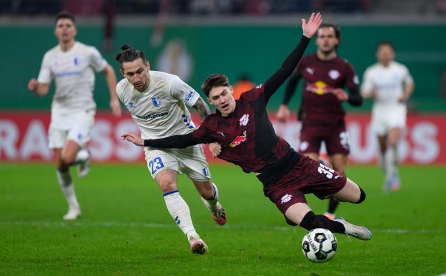 02 December 2025, Saxony, Leipzig: Magdeburg's Baris Atik (L) and Leipzig's Andrija Maksimovic battle for the ball during the German DFB Cup round of 16 soccer match between RB Leipzig and 1. FC Magdeburg at Red Bull Arena. Photo: Hendrik Schmidt/dpa - WICHTIGER HINWEIS: Gemäß den Vorgaben der DFL Deutsche Fußball Liga bzw. des DFB Deutscher Fußball-Bund ist es untersagt, in dem Stadion und/oder vom Spiel angefertigte Fotoaufnahmen in Form von Sequenzbildern und/oder videoähnlichen Fotostrecken zu verwerten bzw. verwerten zu lassen.