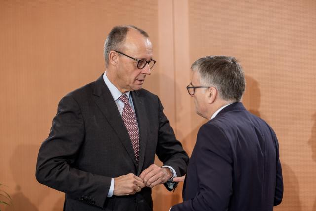 03 December 2025, Berlin: German Chancellor Friedrich Merz (L) speaks with Stefan Kornelius, government spokesman, before the start of the Federal Cabinet meeting in the Chancellery. Photo: Michael Kappeler/dpa
