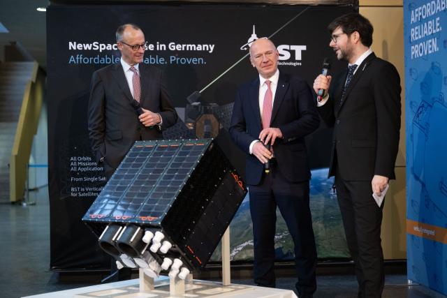 03 December 2025, Berlin: German Chancellor Friedrich Merz (L-R) and Kai Wegner, Governing Mayor of Berlin, talk to Tom Segert, Managing Director of Berlin Space Technologies, during a visit to the company Berlin Space Technologies. Photo: Christophe Gateau/dpa