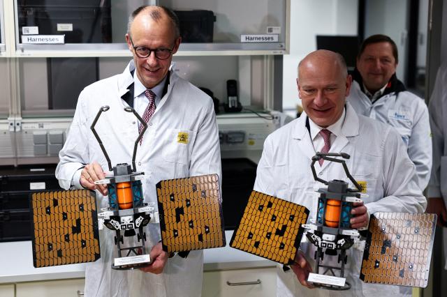 03 December 2025, Berlin: German Chancellor Friedrich Merz (L) and Kai Wegner, Governing Mayor of Berlin, visit Berlin Space Technologies (BST) in the Adlershof district. Photo: Nadja Wohlleben/Reuters/Pool/dpa