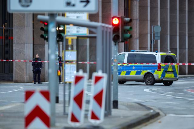 12 March 2025, North Rhine-Westphalia, Moenchengladbach: Police officers block off access to Bismarckplatz in Moenchengladbach city center with their vehicle. Photo: Christoph Reichwein/dpa