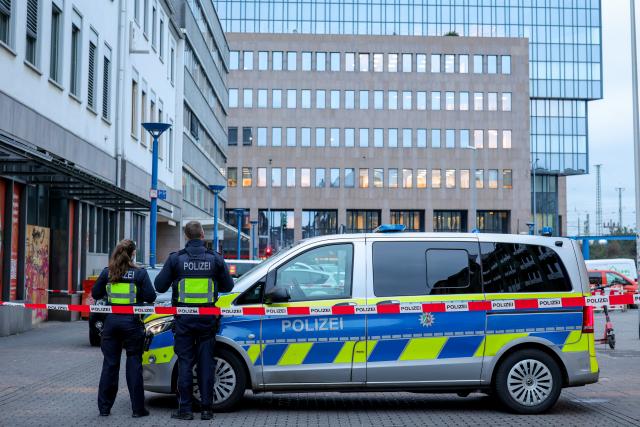12 March 2025, North Rhine-Westphalia, Moenchengladbach: Police officers block off access to Bismarckplatz in Moenchengladbach city center with their vehicle. Photo: Christoph Reichwein/dpa