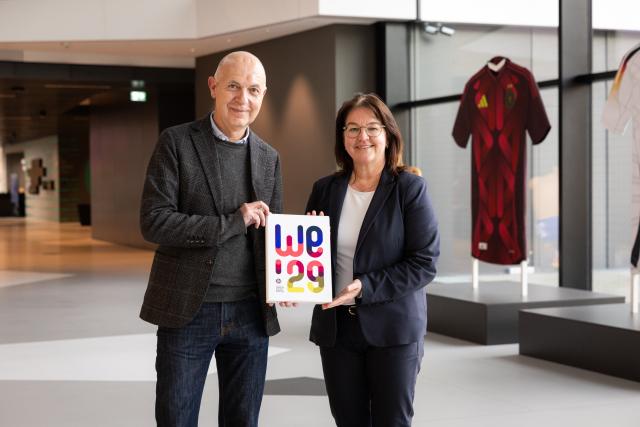HANDOUT - 12 March 2025, Hesse, Frankfurt/Main: DFB President Bernd Neuendorf with DFB General Secretary Heike Ullrich at the DFB Campus in Frankfurt am Main present the bid book for the women's European Championships in 2029. Photo: Yuliia Perekopaiko/DFB/dpa - ATTENTION: editorial use only and only if the credit mentioned above is referenced in full