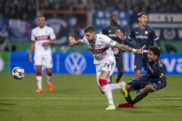 03 December 2024, North Rhine-Westphalia, Bochum: Stuttgart's Jeff Chabot (L) and Bochum's Francis Onyeka battle for the ball during the German DFB Cup round of 16 soccer match between VfL Bochum and VfB Stuttgart at Vonovia Ruhrstadion. Photo: David Inderlied/dpa - IMPORTANT NOTICE: DFL and DFB regulations prohibit any use of photographs as image sequences and/or quasi-video.