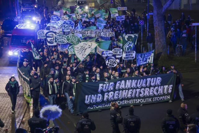 03 December 2025, Bremen: People walk with banners and posters in Bremen's Steintor district during a demonstration by soccer fans under the slogan "For fan culture and freedom rights" against the restriction of fan rights, as the Conference of Interior Ministers (IMK) begins in Bremen. Photo: Focke Strangmann/dpa