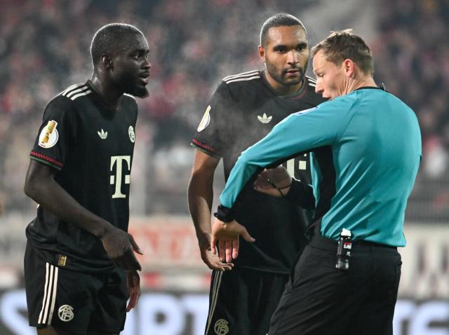 03 December 2025, Berlin: German referee Martin Petersen (R) explains to Bayern Munich's Dayot Upamecano (L) and Jonathan Tah his decision on a penalty for Union Berlin after viewing the VAR images during the German DFB Cup round of 16 soccer match between 1. FC Union Berlin and FC Bayern Munich at an der Alten Foersterei. Photo: Soeren Stache/dpa - IMPORTANT NOTE: In accordance with the regulations of the DFL German Football League and the DFB German Football Association, it is prohibited to utilize or have utilized photographs taken in the stadium and/or of the match in the form of sequential images and/or video-like photo series.