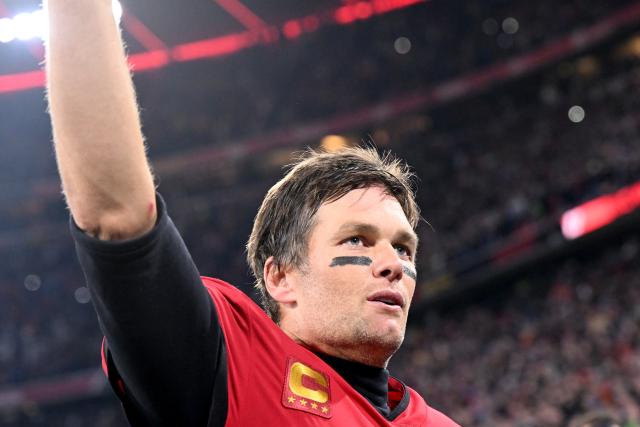 FILED - 13 November 2022, Bavaria, Munich: Tom Brady, then quarterback of the Tampa Bay Buccaneers, cheers for the fans after the NFL professional league American Football match bewteen Tampa Bay Buccaneers and Seattle Seahawks at Allianz Arena. Four of North America's biggest sports stars will take centre stage at Friday's World Cup draw, FIFA announced on Wednesday. Photo: Sven Hoppe/dpa