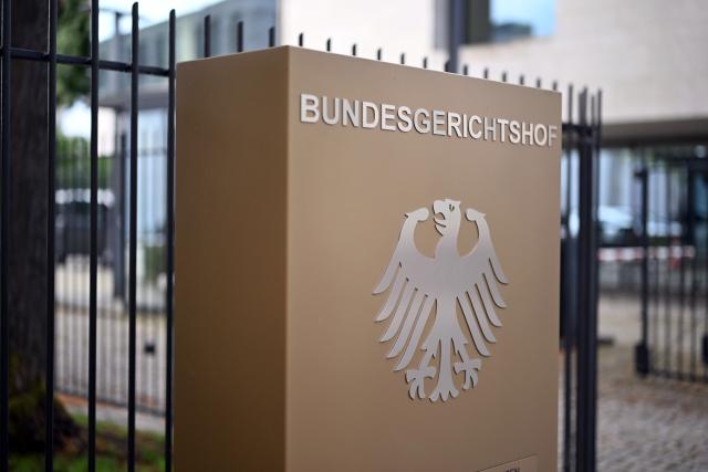FILED - 29 July 2025, Baden-Wuerttemberg, Karlsruhe: A sign with a federal eagle and the words Federal Court of Justice (BGH), taken in front of the BGH. Germany must immediately take in a former Afghan judge and his family, the Constitutional Court ruled in an urgent judgement published on Thursday. Photo: Uli Deck/dpa