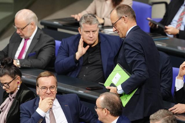 05 December 2025, Berlin: German Chancellor Friedrich Merz (R) stands near Boris Pistorius, Minister of Defence (2nd L) during the German Bundestag session on the modernization of military service. Photo: Kay Nietfeld/dpa