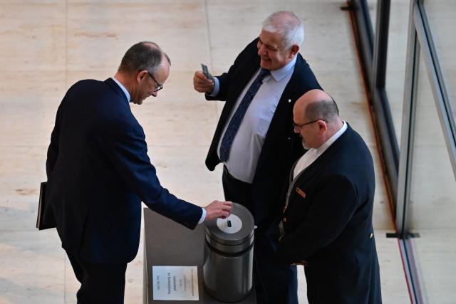 05 December 2025, Berlin: German Chancellor Friedrich Merz casts his vote in the German Bundestag in a roll-call vote on the law for a new military service. Photo: Sebastian Christoph Gollnow/dpa