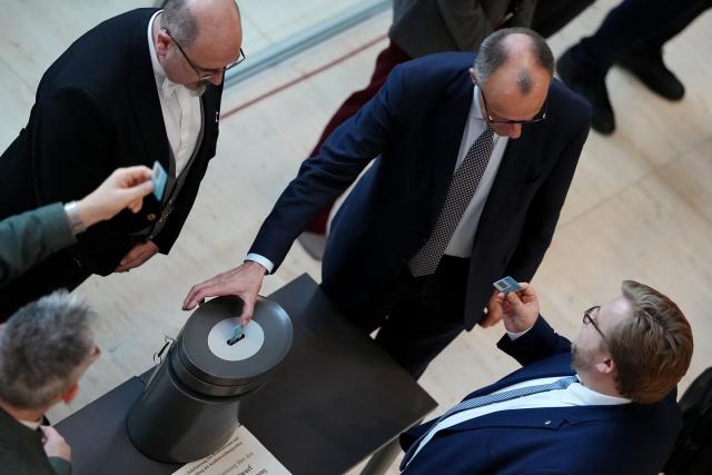 05 December 2025, Berlin: German Chancellor Friedrich Merz casts his vote in a roll-call vote on the pension package in the German Bundestag. Photo: Kay Nietfeld/dpa