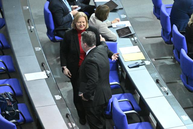 05 December 2025, Berlin: Baerbel Bas, German Minister of Labor and Social Affairs, and Hubertus Heil (SPD), Member of the Bundestag, stand in the plenary chamber on the sidelines of the German Bundestag session. Photo: Christophe Gateau/dpa