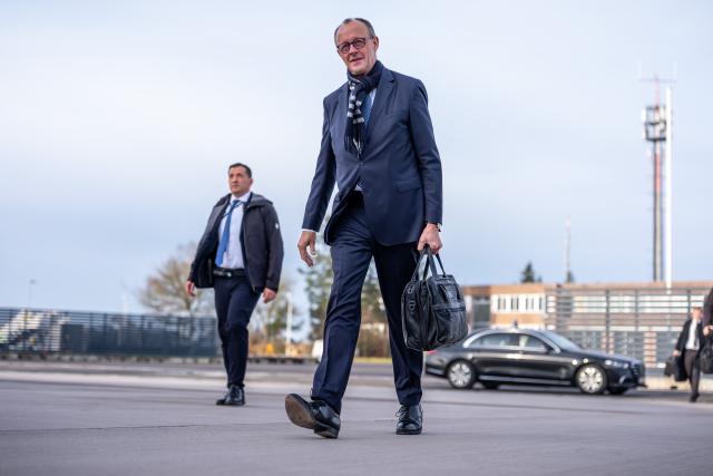 06 December 2025, Brandenburg, Schönefeld: Germany's Chancellor Friedrich Merz arrives at BER Airport to depart for his inaugural visits to Jordan and Israel. Photo: Michael Kappeler/dpa