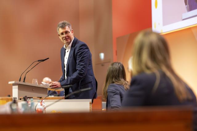 06 December 2025, Hesse, Frankfurt/Main: German Olympic Sports Federation (DOSB) President Thomas Weikert speaks during the opening of the DOSB General Assembly in Frankfurt. The meeting is set to vote today on a bid to host the Olympic and Paralympic Games in Germany. Photo: Helmut Fricke/dpa