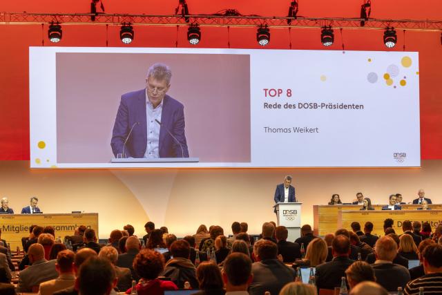 06 December 2025, Hesse, Frankfurt/Main: German Olympic Sports Federation (DOSB) President Thomas Weikert speaks during the opening of the DOSB General Assembly in Frankfurt. The meeting is set to vote today on a bid to host the Olympic and Paralympic Games in Germany. Photo: Helmut Fricke/dpa