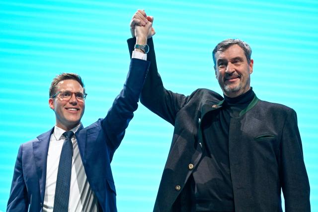 06 December 2025, Baden-Wuerttemberg, Heidelberg: Manuel Hagel (L), state chairman of the CDU in Baden-Wuerttemberg, and Bavaria's Minister President Markus Soeder, hold hands at the Christian Democratic Union (CDU) state party conference in Baden-Wuerttemberg. Photo: Uwe Anspach/dpa