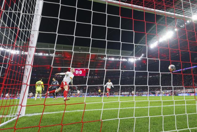 06 December 2025, Saxony, Leipzig: Leipzig's Conrad Harder celebrates after scoring his side's first goal during the German Bundesliga soccer match between RB Leipzig and Eintracht Frankfurt at the Red Bull Arena. Photo: Jan Woitas/dpa - IMPORTANT NOTICE: DFL and DFB regulations prohibit any use of photographs as image sequences and/or quasi-video.