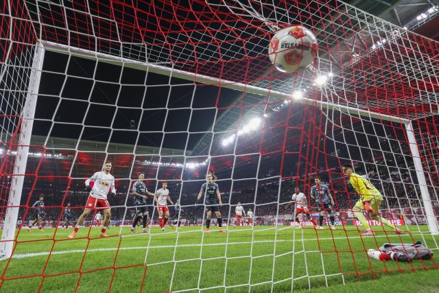 06 December 2025, Saxony, Leipzig: Leipzig's Christoph Baumgartner scores against Eintracht Frankfurt goalkeeper Michael Zetterer during the German Bundesliga soccer match between RB Leipzig and Eintracht Frankfurt at the Red Bull Arena. Photo: Jan Woitas/dpa - IMPORTANT NOTICE: DFL and DFB regulations prohibit any use of photographs as image sequences and/or quasi-video.