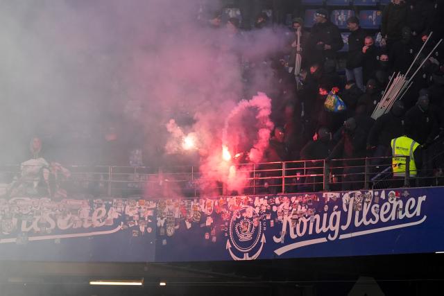 07 December 2025, Hamburg: Werder Bremen fans set off pyrotechnics in the stands ahead of the German Bundesliga soccer match between Hamburger SV and SV Werder Bremen at the Volksparkstadion. Photo: Marcus Brandt/dpa - IMPORTANT NOTICE: DFL and DFB regulations prohibit any use of photographs as image sequences and/or quasi-video.