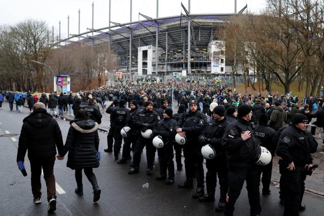 07 December 2025, Hamburg: Police officers stand in front of the Volksparkstadion ahead of the German Bundesliga soccer match between Hamburger SV and SV Werder Bremen. Photo: Christian Charisius/dpa - IMPORTANT NOTICE: DFL and DFB regulations prohibit any use of photographs as image sequences and/or quasi-video.