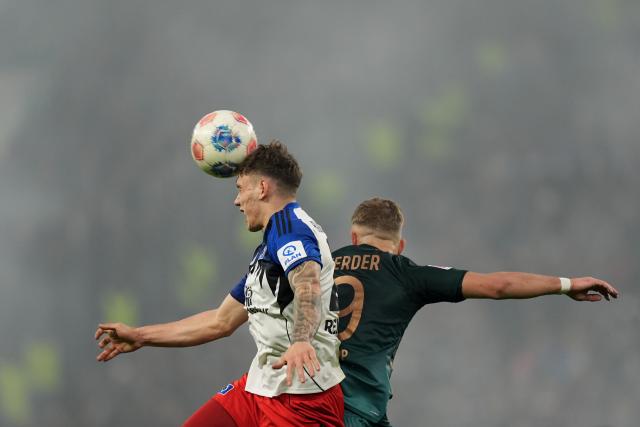07 December 2025, Hamburg: Hamburger's Nicolai Remberg (L) and Werder Bremen's Keke Topp battle for the ball during the German Bundesliga soccer match between Hamburger SV and SV Werder Bremen at the Volksparkstadion. Photo: Marcus Brandt/dpa - IMPORTANT NOTICE: DFL and DFB regulations prohibit any use of photographs as image sequences and/or quasi-video.