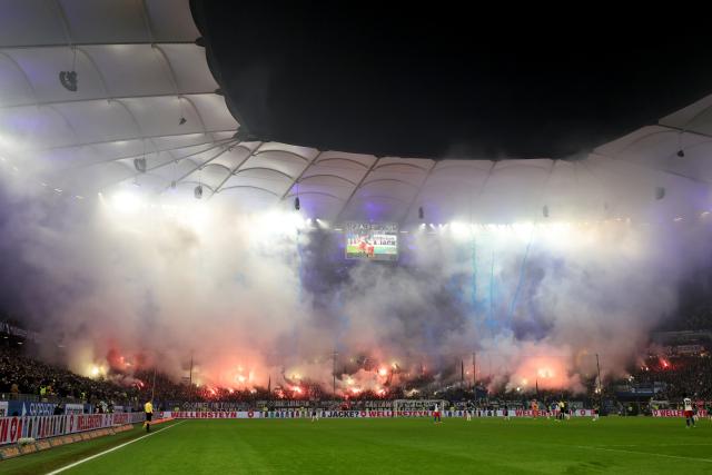 07 December 2025, Hamburg: Hamburger fans set off pyrotechnics during the German Bundesliga soccer match between Hamburger SV and SV Werder Bremen at the Volksparkstadion. Photo: Christian Charisius/dpa - IMPORTANT NOTICE: DFL and DFB regulations prohibit any use of photographs as image sequences and/or quasi-video.