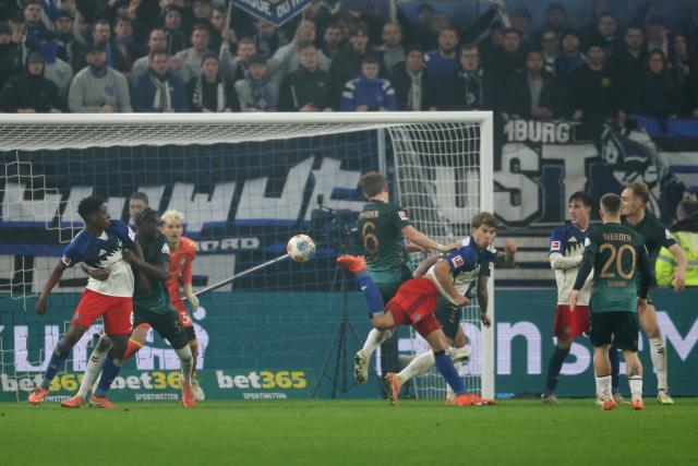 07 December 2025, Hamburg: Hamburger's Luka Vuskovic (4th R) scores his side's second goal during the German Bundesliga soccer match between Hamburger SV and SV Werder Bremen at the Volksparkstadion. Photo: Christian Charisius/dpa - IMPORTANT NOTICE: DFL and DFB regulations prohibit any use of photographs as image sequences and/or quasi-video.