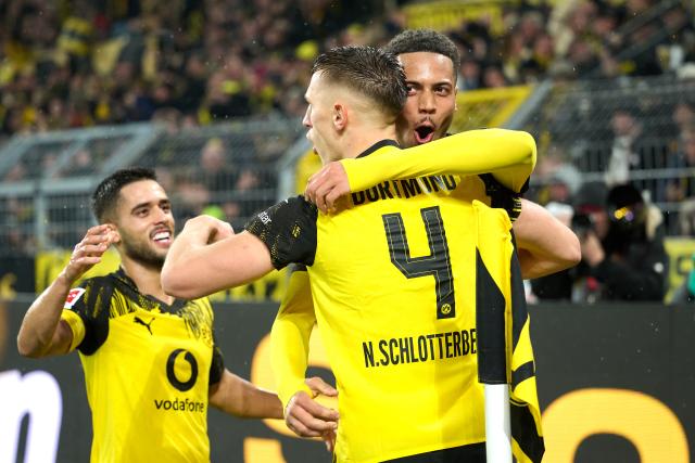07 December 2025, North Rhine-Westphalia, Dortmund: Borussia Dortmund's Nico Schlotterbeck (C) celebrates scoring his side's second goal with teammates Yan Couto (L) and Felix Nmecha during the German Bundesliga soccer match between Borussia Dortmund and TSG 1899 Hoffenheim at Signal Iduna Park. Photo: Bernd Thissen/dpa - IMPORTANT NOTE: In accordance with the regulations of the DFL German Football League and the DFB German Football Association, it is prohibited to utilize or have utilized photographs taken in the stadium and/or of the match in the form of sequential images and/or video-like photo series.