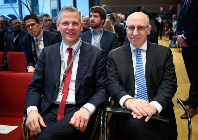08 December 2025, Berlin: Christoph de Vries (L), Parliamentary State Secretary at the Federal Ministry of the Interior, and Sinan Selen, President of the Federal Office for the Protection of the Constitution (BfV), sit at the 21st symposium of the Federal Office for the Protection of the Constitution (BfV). Under the heading "Turning point - and now?", the one-day event will examine the role of the BfV in Germany's security architecture. Photo: Bernd von Jutrczenka/dpa