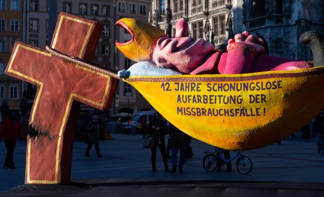 FILED - 19 January 2022, Bavaria, Munich: The sculpture 'The Hammock Bishop' stands on Marienplatz. Photo: Sven Hoppe/dpa