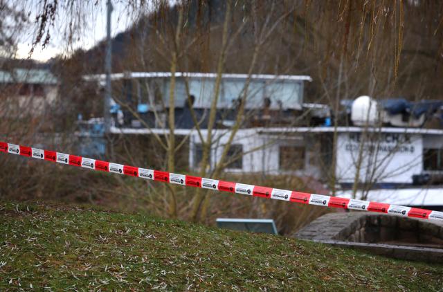 08 December 2025, Bavaria, Randersacker: A cargo ship that cannot continue its journey due to the blocked river stands behind a barrier on the Main. Diesel fuel leaked into the Main during the shipping accident on Saturday after a passenger ship full of several hundred people was wrecked on the Main in Lower Franconia. Photo: Karl-Josef Hildenbrand/dpa