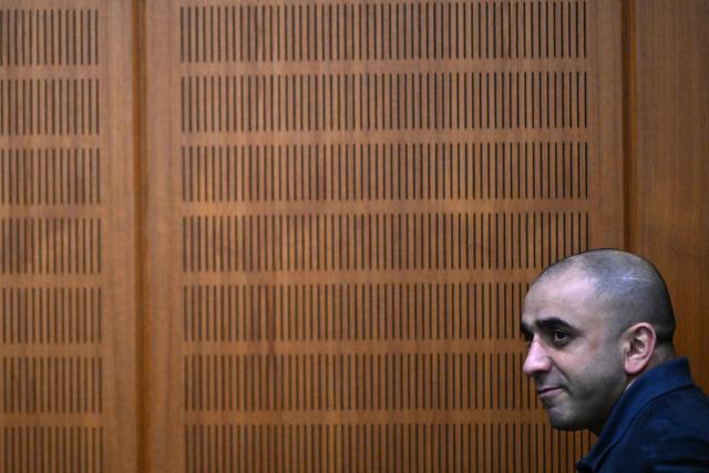 09 December 2025, Hesse, Frankfurt/Main: Russian defendant Arman S. sits in the courtroom on the opening day of the trial against three men for spying for Russia. Three men are said to have had a man in their sights for a Russian secret service. A crucial meeting is said to have been planned in a cafe in Frankfurt. Now the trial begins. Photo: -/POOL/AFP/dpa