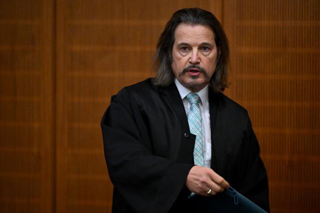 09 December 2025, Hesse, Frankfurt/Main: Andreas Bensch, lawyer for co-defendant Russian Arman S., stands in the courtroom on the first day of the trial against three men for spying for Russia. Three men are said to have had a man in their sights for a Russian secret service. A crucial meeting is said to have been planned in a cafe in Frankfurt. Now the trial begins. Photo: -/POOL/AFP/dpa