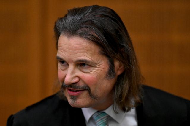 09 December 2025, Hesse, Frankfurt/Main: Andreas Bensch, lawyer for co-defendant Russian Arman S., stands in the courtroom on the first day of the trial against three men for spying for Russia. Three men are said to have had a man in their sights for a Russian secret service. A crucial meeting is said to have been planned in a cafe in Frankfurt. Now the trial begins. Photo: -/POOL/AFP/dpa